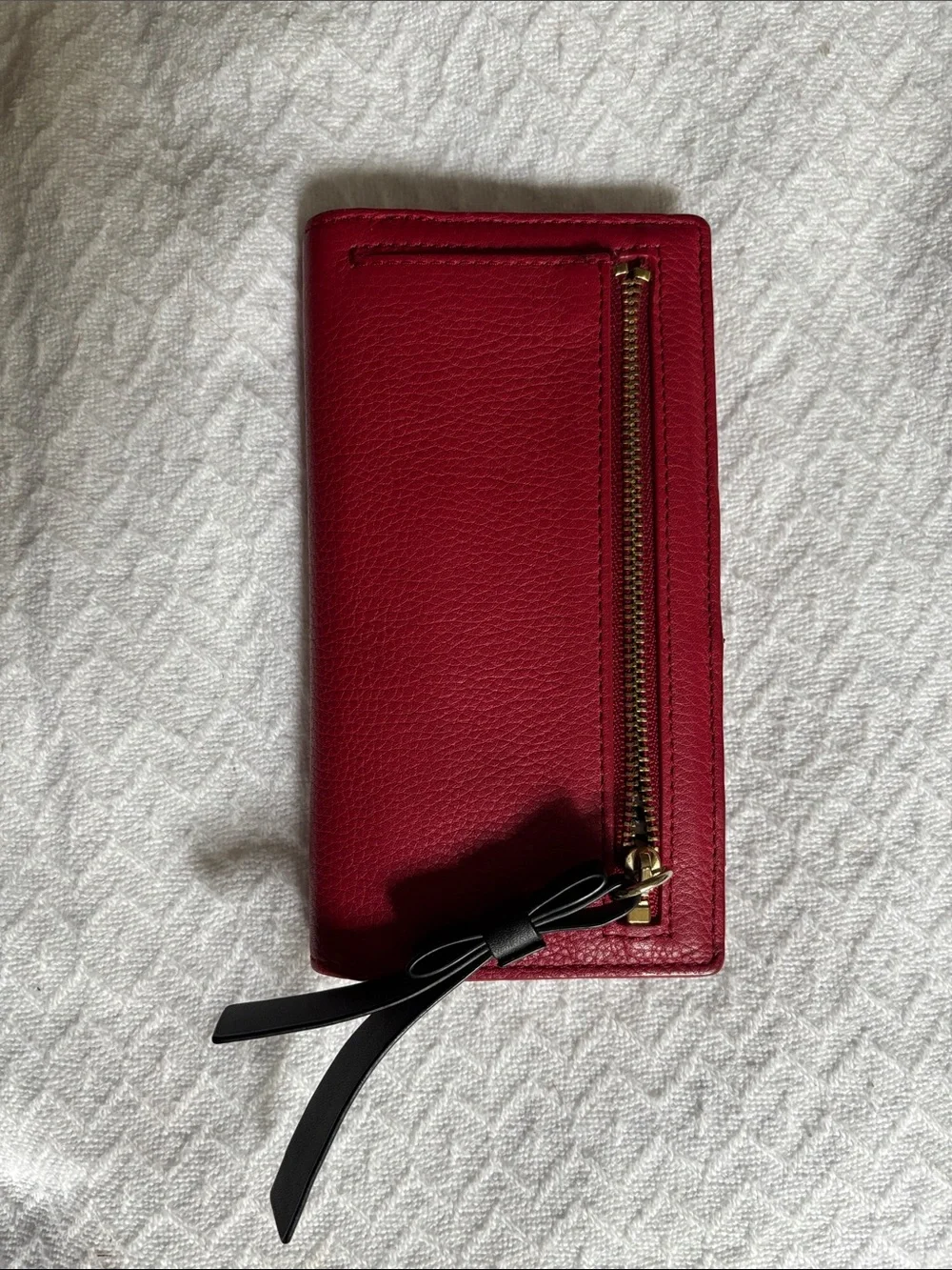 kate spade red pebbled leather zip wristlet with black strap